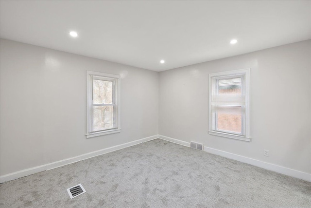 spare room with light colored carpet