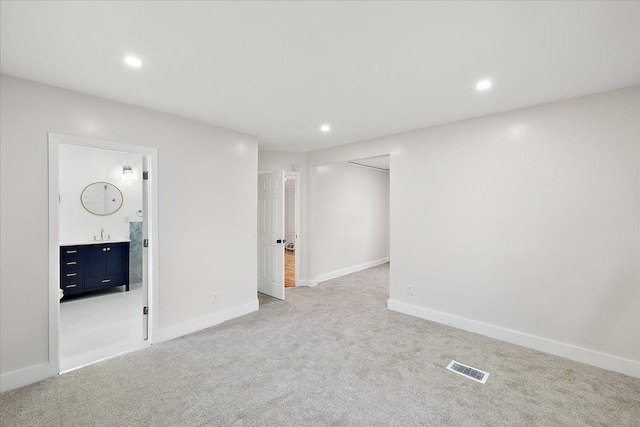 empty room with light colored carpet