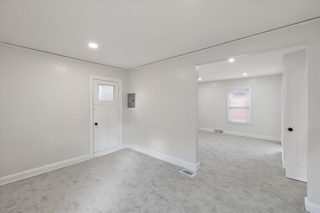 foyer entrance with light colored carpet and electric panel