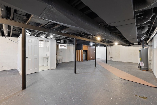 basement featuring sink and gas water heater