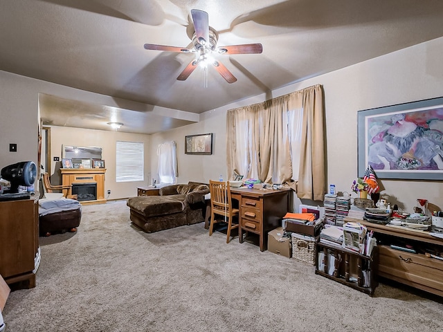 carpeted office space featuring ceiling fan