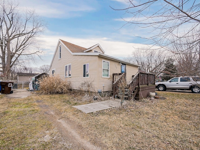 view of side of home with a lawn