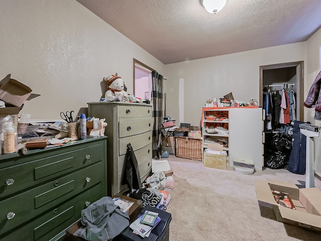 carpeted bedroom with a closet and a textured ceiling