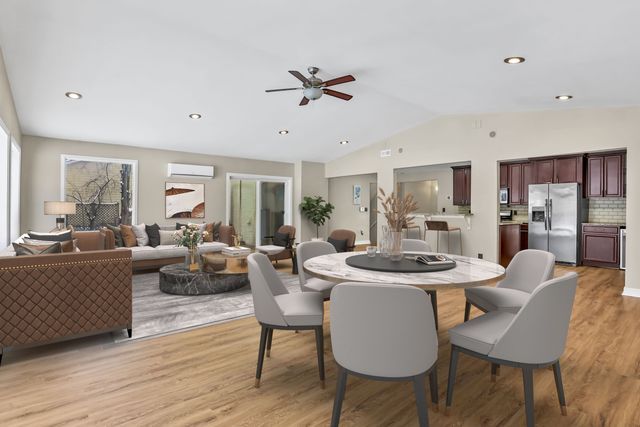 dining area featuring ceiling fan, lofted ceiling, a wall unit AC, and light hardwood / wood-style flooring