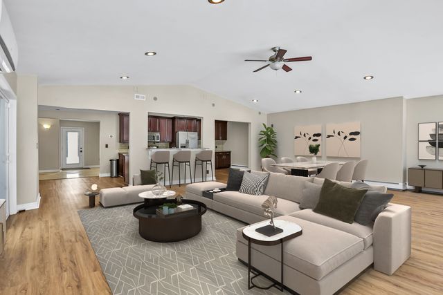 living room featuring lofted ceiling, light hardwood / wood-style floors, and ceiling fan