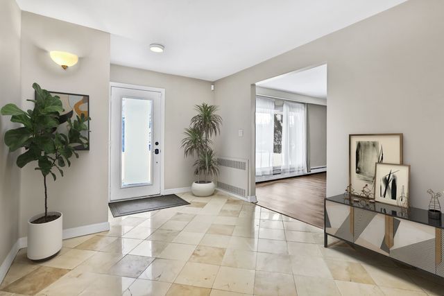 foyer entrance featuring radiator and light tile patterned floors