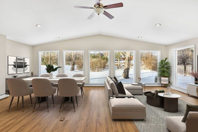 sunroom / solarium with ceiling fan and lofted ceiling