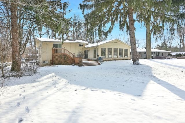 view of snow covered rear of property