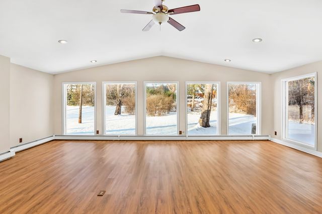 unfurnished sunroom featuring vaulted ceiling and ceiling fan