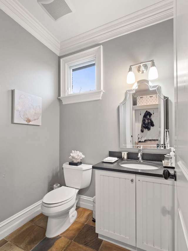 bathroom with crown molding, vanity, and toilet