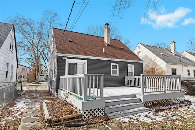 snow covered house with a deck