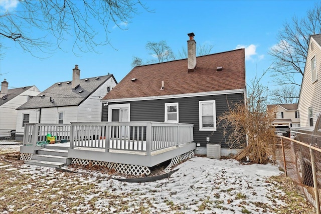 snow covered property featuring a wooden deck