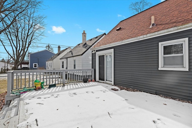 snow covered deck featuring a patio