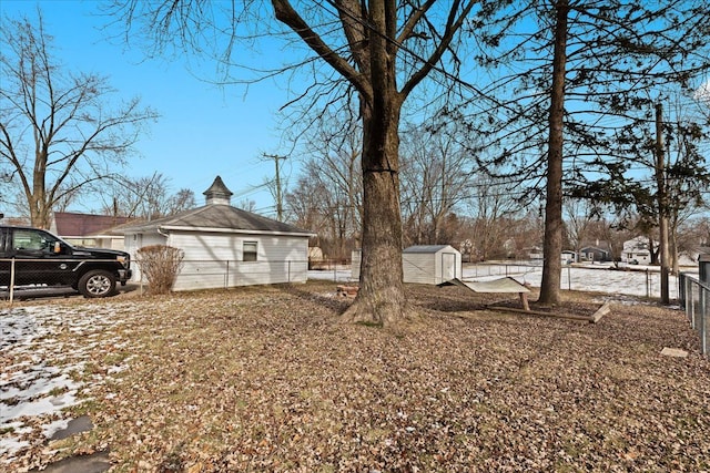 snowy yard with a shed