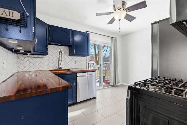 kitchen with wood counters, blue cabinets, dishwasher, sink, and gas range oven