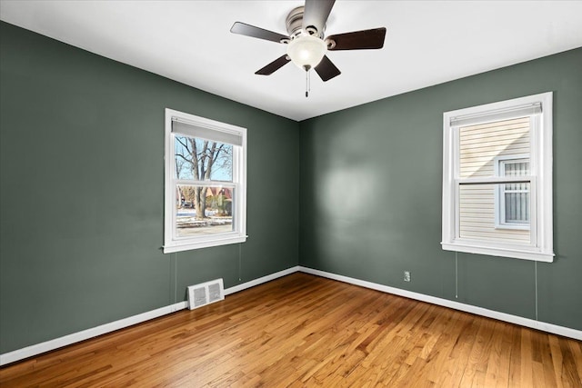 spare room featuring ceiling fan and light hardwood / wood-style flooring