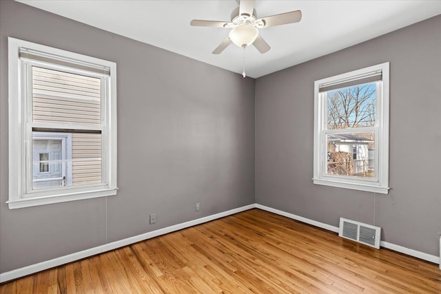 spare room featuring ceiling fan and light hardwood / wood-style flooring