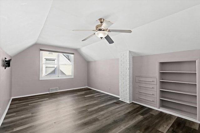 bonus room with dark wood-type flooring, ceiling fan, vaulted ceiling, and built in features