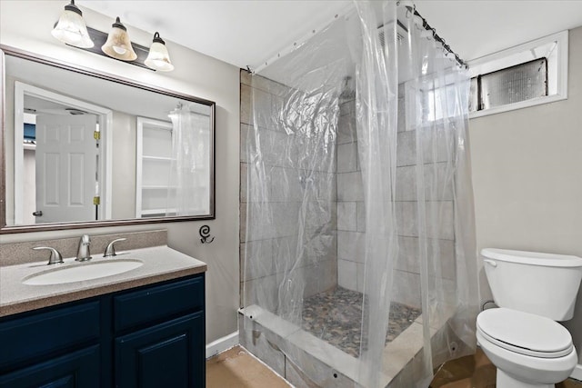 bathroom with vanity, a shower with curtain, and toilet