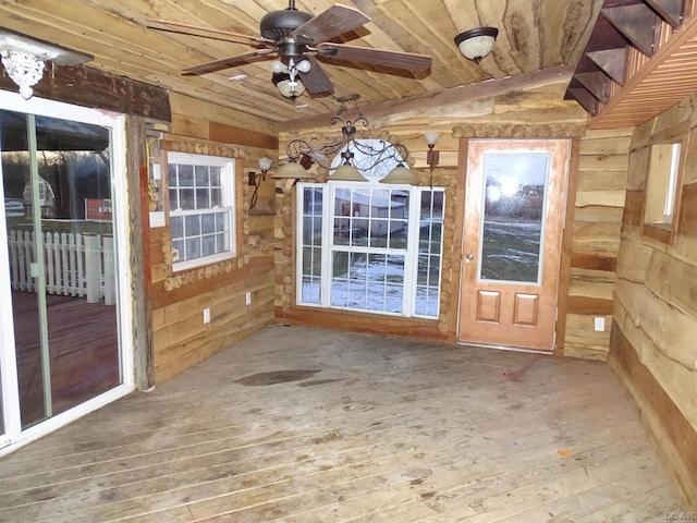 unfurnished sunroom featuring wood ceiling and ceiling fan