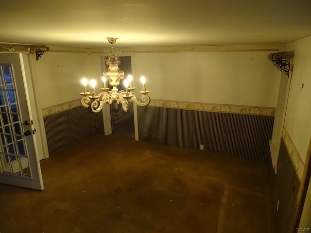 unfurnished dining area with dark colored carpet and a notable chandelier