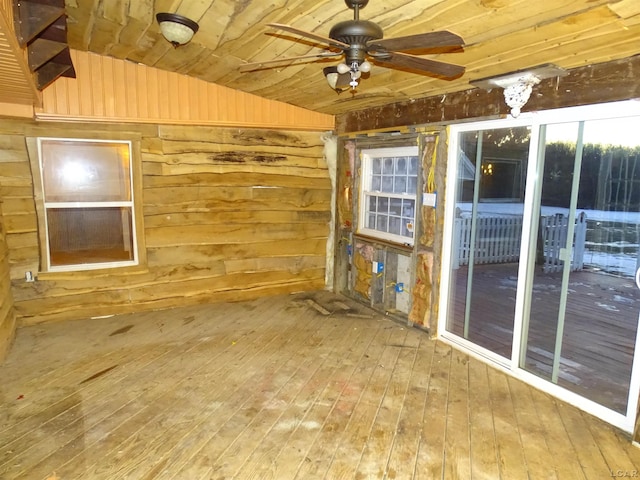 empty room featuring wood-type flooring, ceiling fan, wooden ceiling, and wooden walls