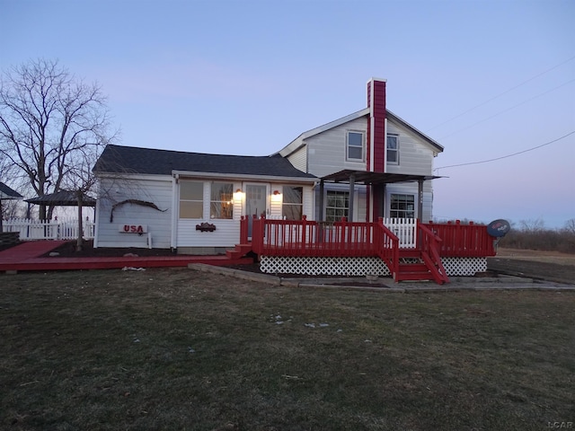 view of front of house with a wooden deck, a yard, and a pergola