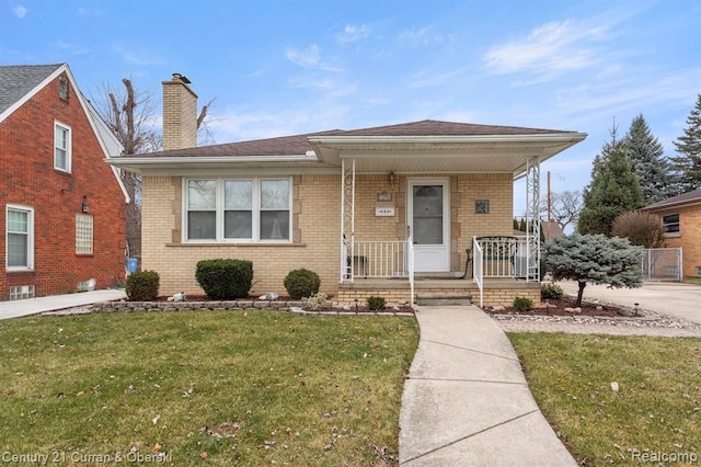 view of front of property with a porch and a front yard