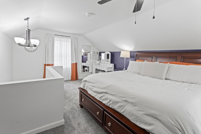 carpeted bedroom featuring lofted ceiling and ceiling fan with notable chandelier