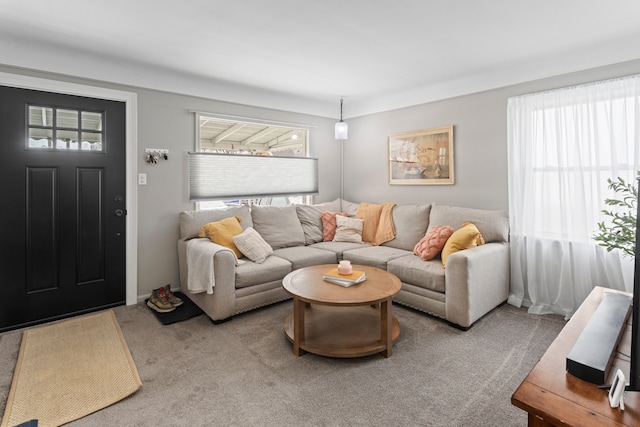 living room with plenty of natural light and light colored carpet