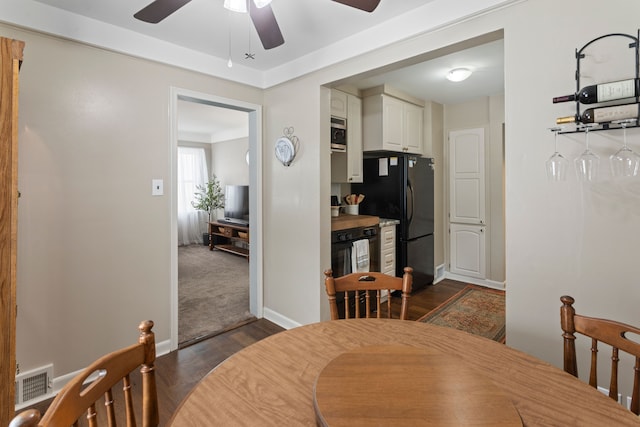 dining room with ceiling fan and dark hardwood / wood-style floors