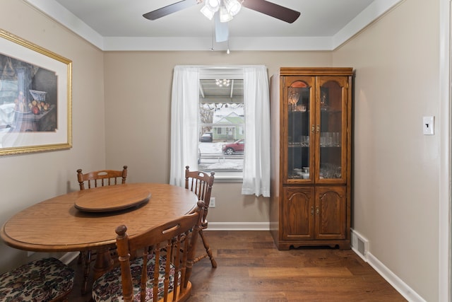 dining space featuring ceiling fan and dark hardwood / wood-style flooring