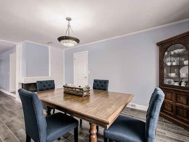 dining area with wood-type flooring and crown molding