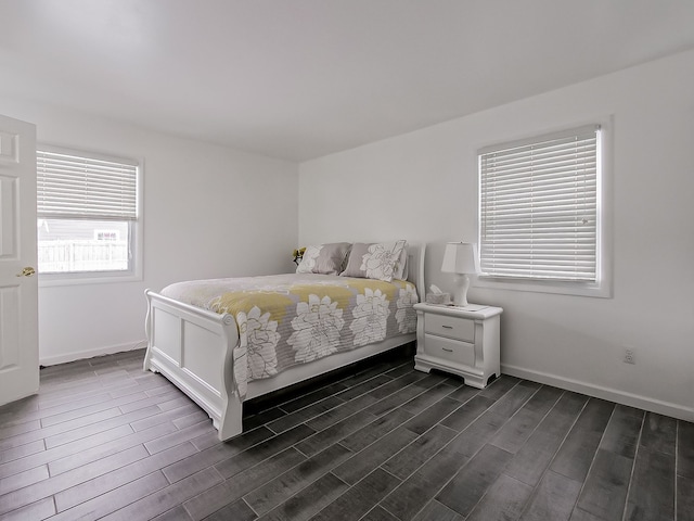 bedroom with dark hardwood / wood-style flooring