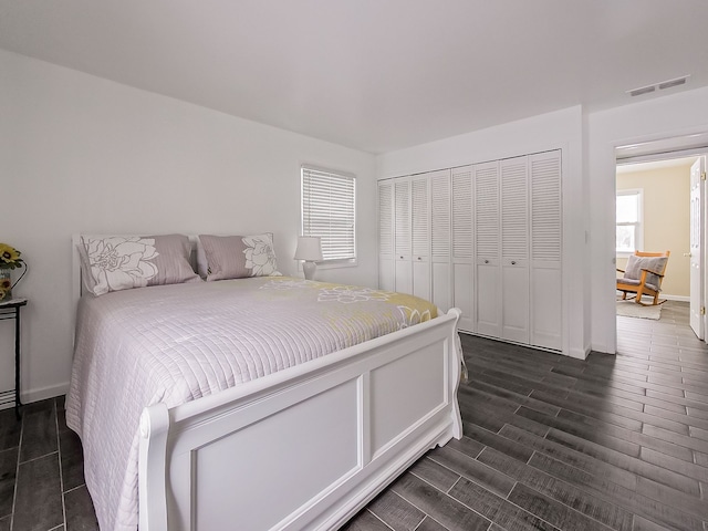 bedroom featuring dark hardwood / wood-style floors and a closet