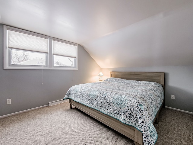 carpeted bedroom with a baseboard radiator and lofted ceiling