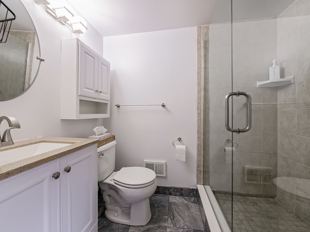 bathroom featuring vanity, toilet, and a shower with shower door