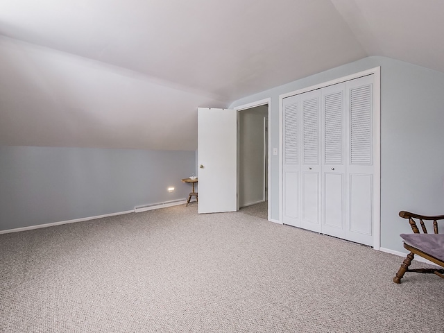 bonus room featuring a baseboard radiator, lofted ceiling, and carpet flooring