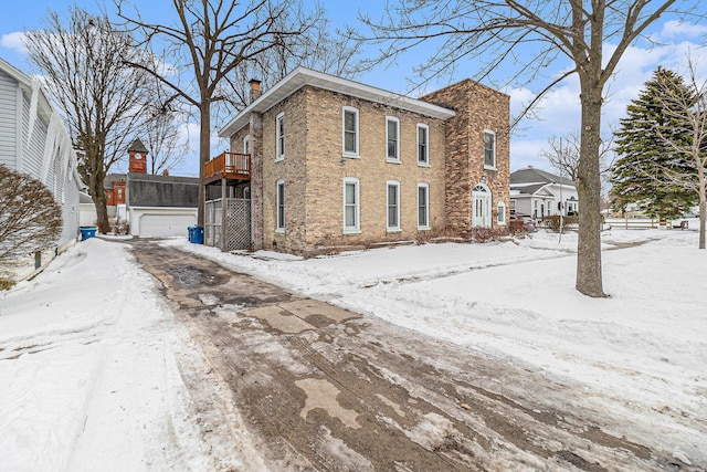 snow covered property featuring a wooden deck