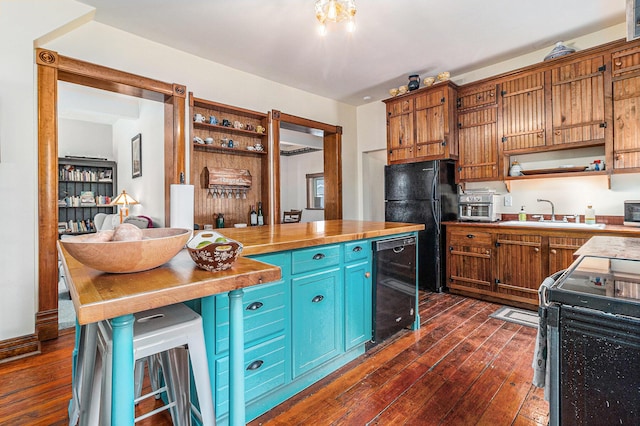 kitchen with sink, dark wood-type flooring, black refrigerator, electric range, and wood counters