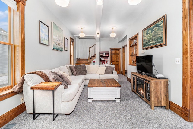 living room featuring a wealth of natural light and carpet flooring