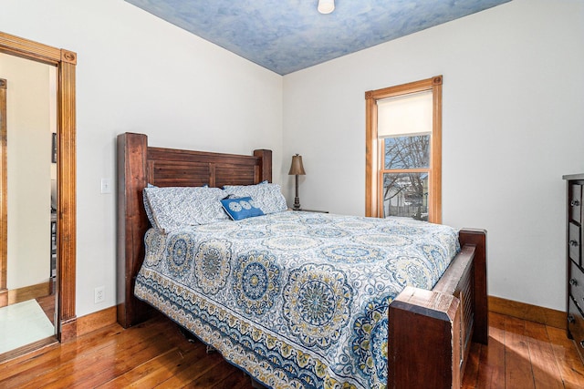 bedroom with dark hardwood / wood-style floors