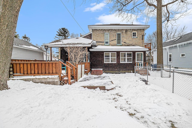 view of snow covered rear of property