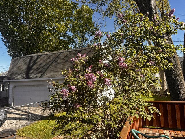 305 E Filer St, Ludington, MI 49431 - view of side of home featuring fence and an attached garage