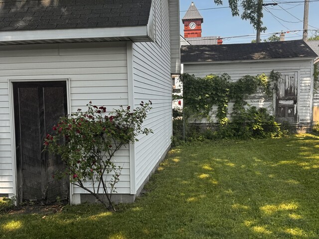 305 E Filer St, Ludington, MI 49431 - view of home's exterior with a lawn and a shingled roof