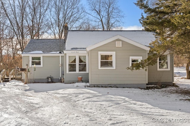 view of snow covered rear of property