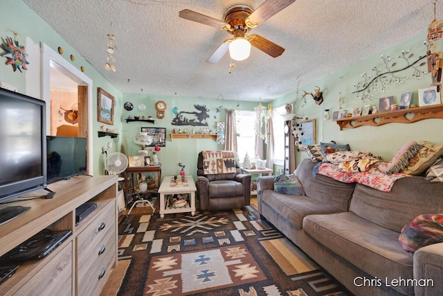 living room featuring a textured ceiling and ceiling fan