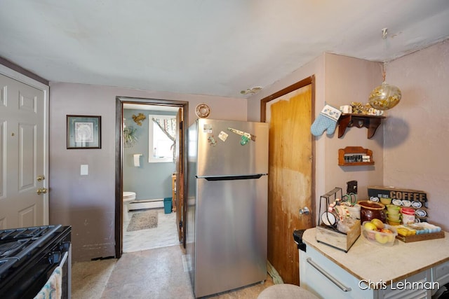 kitchen featuring appliances with stainless steel finishes and a baseboard heating unit