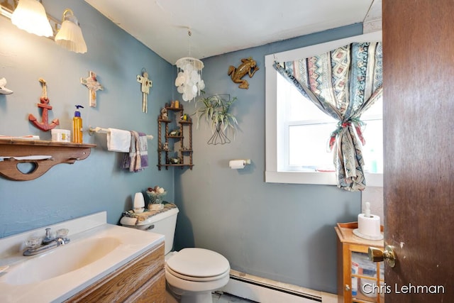 bathroom with vanity, toilet, and baseboard heating