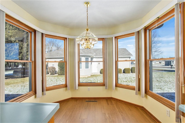 unfurnished sunroom with an inviting chandelier